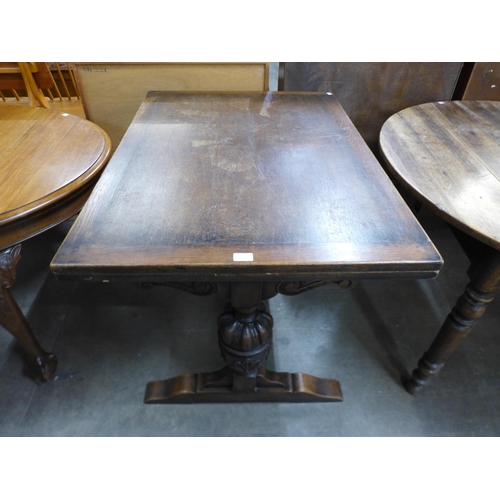 172 - A carved oak draw-leaf table