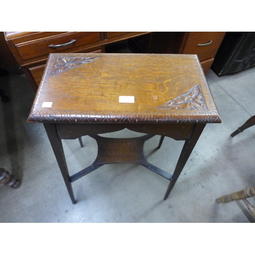 177 - An Arts and Crafts carved oak occasional table