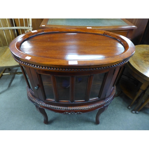 183 - A hardwood oval tray topped display table