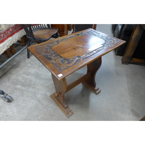 214 - An early 20th Century carved oak occasional table