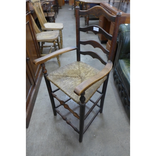 218 - An Arts and Crafts elm rush seated child's chair