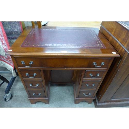 219 - A George II style yew wood kneehole desk