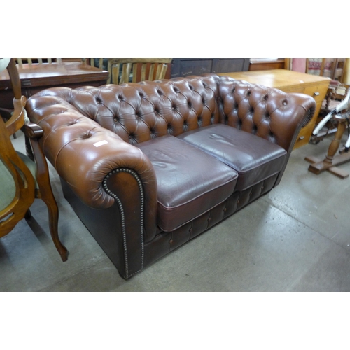 231 - A brown leather Chesterfield settee