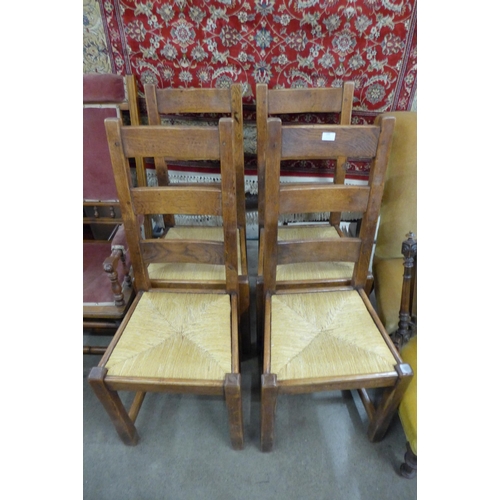 235 - A set of four oak and rush seated chairs