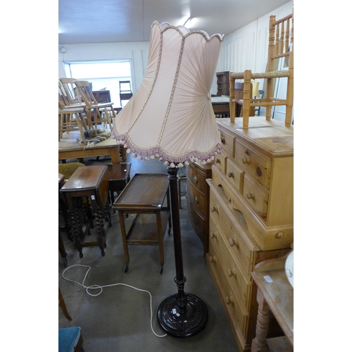 239 - A carved mahogany standard lamp