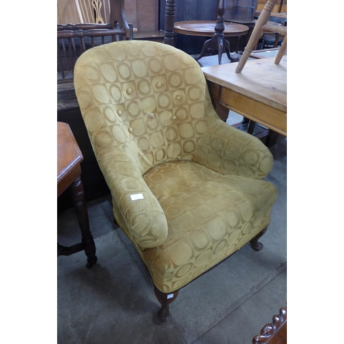 244 - An early 20th Century upholstered armchair