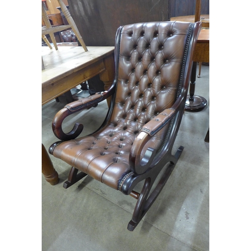 249 - A mahogany and brown leather rocking chair