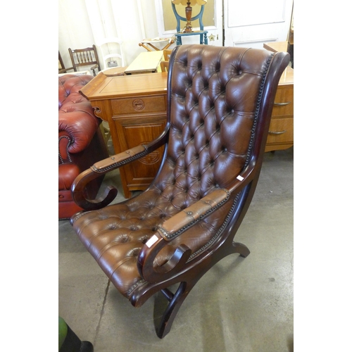 250 - A mahogany and brown leather armchair