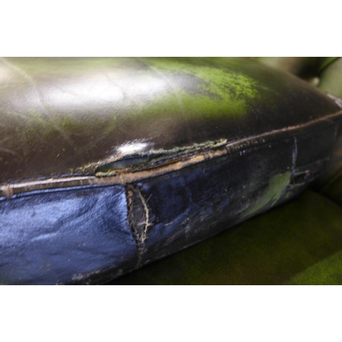 251 - A green leather Chesterfield wingback settee ( tear to seat cushion)