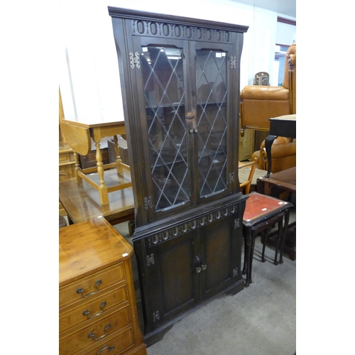 266 - A carved oak freestanding corner cabinet