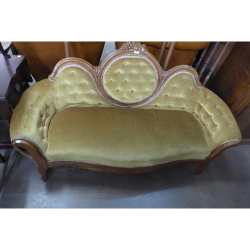 268 - A Victorian style walnut and fabric upholstered salon settee