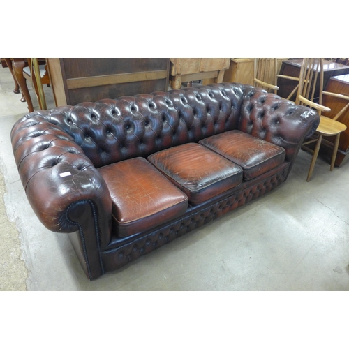 286 - A burgundy leather Chesterfield settee