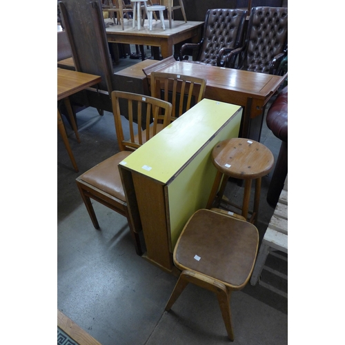 293 - A small Formica kitchen table, two stools and two chairs