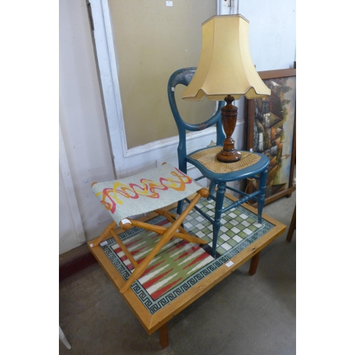 297 - A beech fold out stool, a painted chair and a pine tapestry topped coffee table