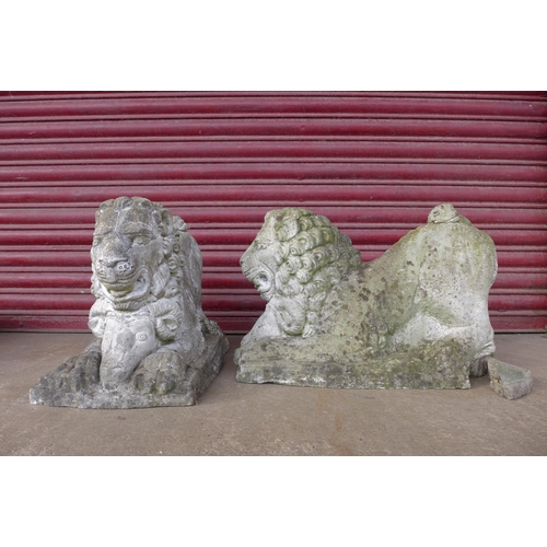 302 - A pair of concrete garden figures of lions capturing rams