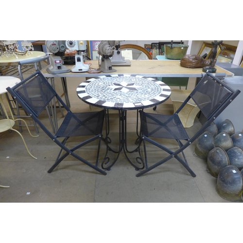 330 - A circular garden table and two chairs