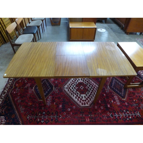 68 - A teak extending dining table