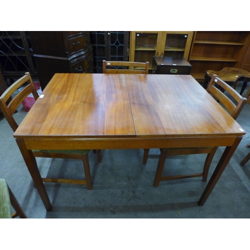 87 - A McIntosh teak extending dining table and four chairs