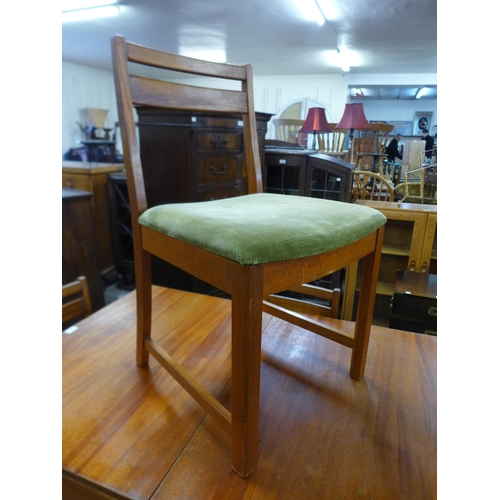 87 - A McIntosh teak extending dining table and four chairs