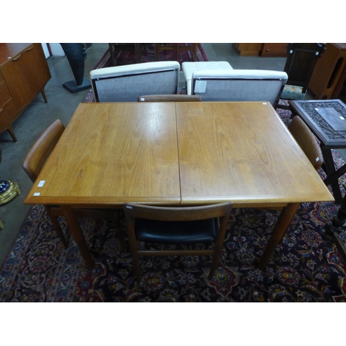 93 - A Dalescraft teak extending dining table and four chairs