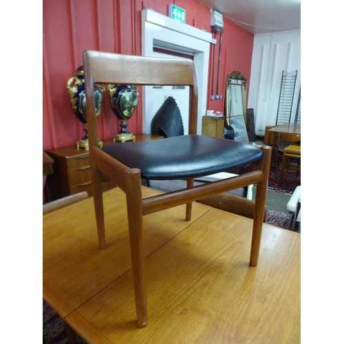 93 - A Dalescraft teak extending dining table and four chairs