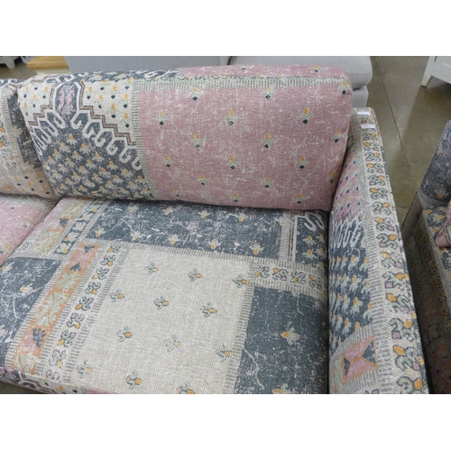 1350 - A blue, pink and cream upholstered four seater sofa