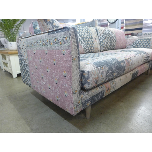 1350 - A blue, pink and cream upholstered four seater sofa