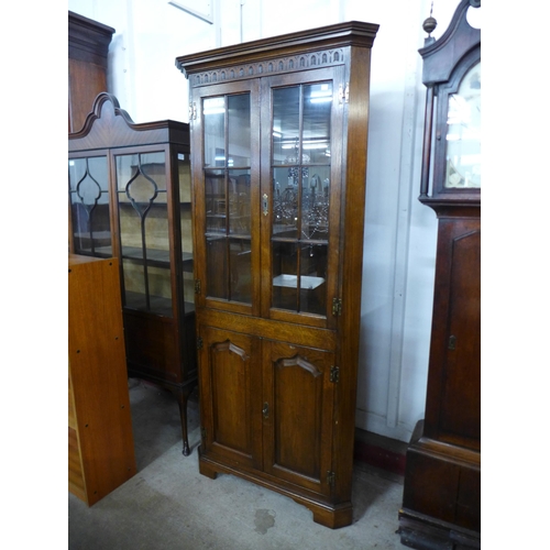 141 - A George III style Ipswich oak freestanding corner cabinet