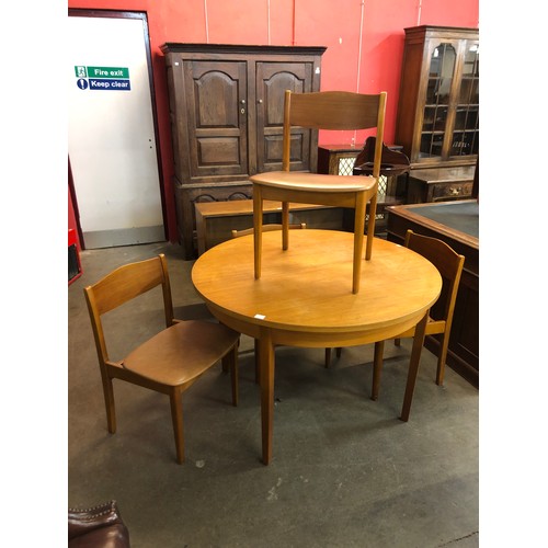 105a - A teak extending dining table and four chairs