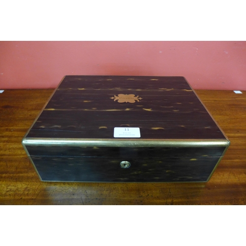 11 - A Regency coromandel and brass inlaid lady's sewing box, with silver mounted glass bottles