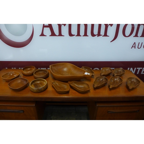 110 - A pear shaped teak fruit bowl, eight other pear shaped bowls and other bowls