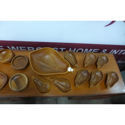 110 - A pear shaped teak fruit bowl, eight other pear shaped bowls and other bowls