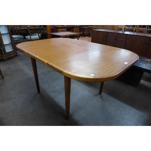 122 - A Danish teak extending dining table