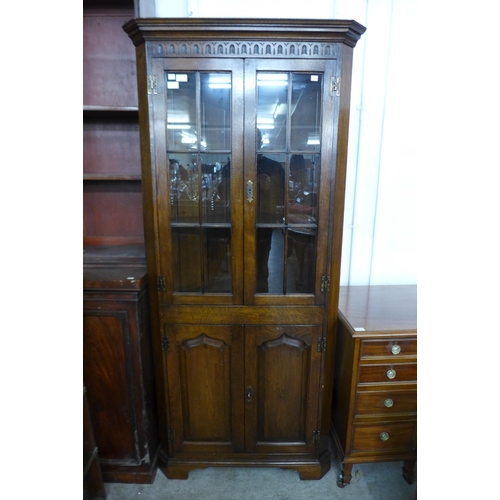 141 - A George III style Ipswich oak freestanding corner cabinet