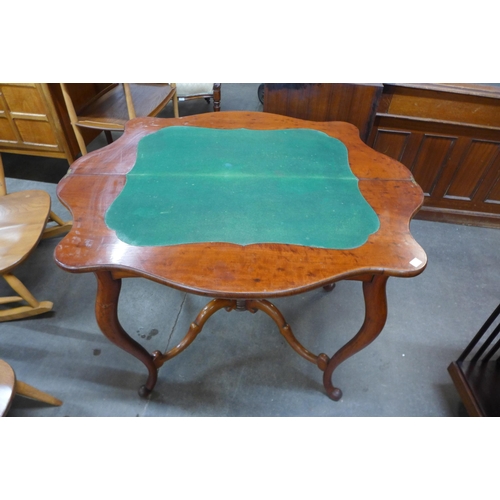 30 - A Victorian mahogany fold over serpentine card table