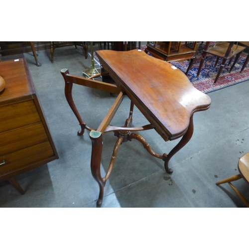 30 - A Victorian mahogany fold over serpentine card table