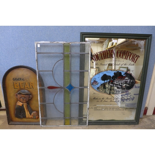 351 - A Southern Comfort advertising mirror, a stained glass pane and a General Bear relief plaque