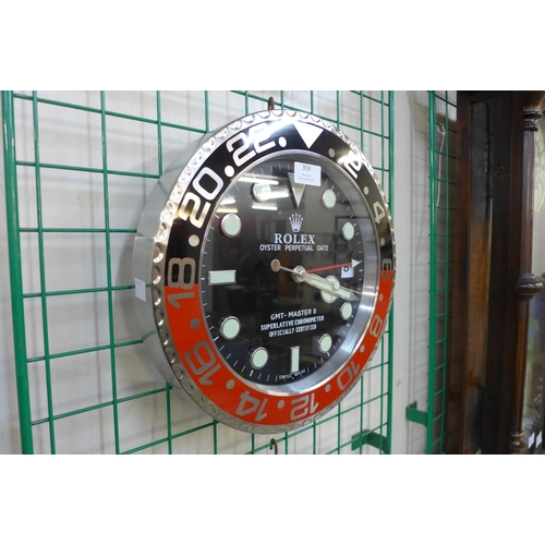 359 - A Rolex style dealer's display circular wall clock