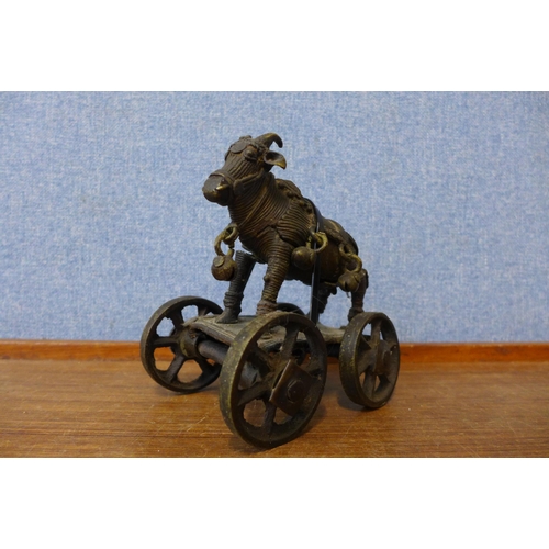 385 - An Indian bronze figure of an ox on wheels, a/f