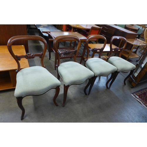 41 - A set of four Victorian rosewood balloon back dining chairs