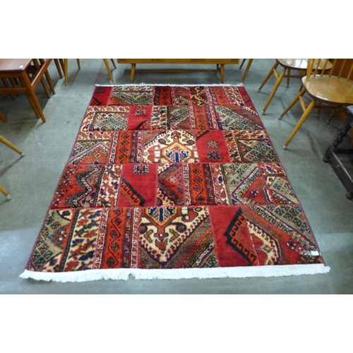 46 - A Persian hand knotted wool patchwork red ground rug