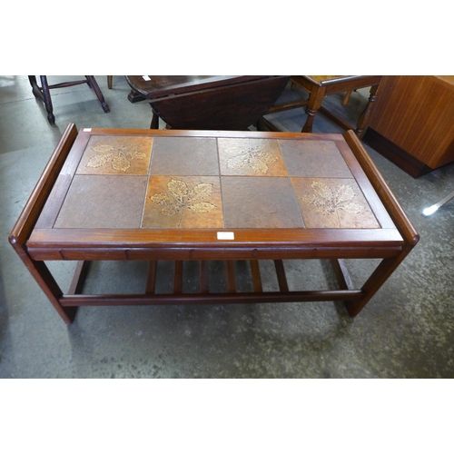 65 - A teak and tiled top coffee table