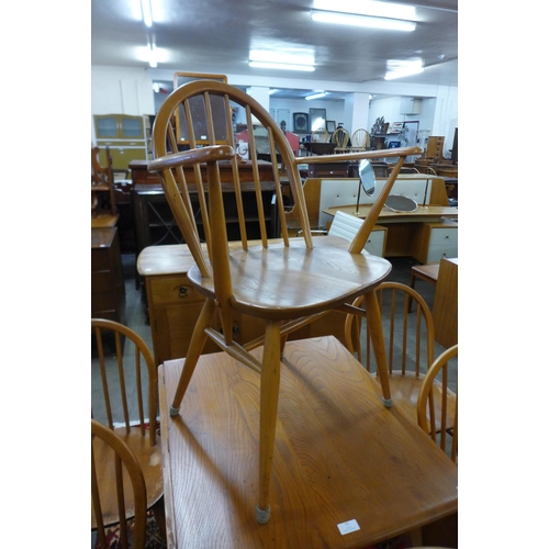 77 - An Ercol Blonde elm and beech Windsor drop-leaf table and six chairs