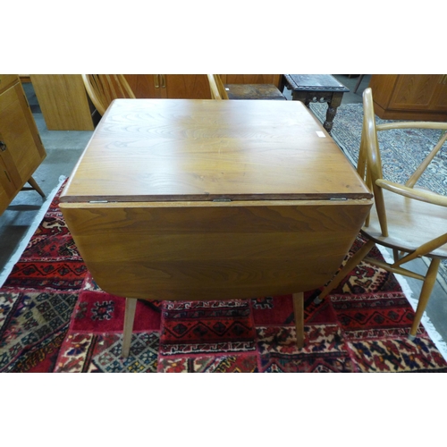 77 - An Ercol Blonde elm and beech Windsor drop-leaf table and six chairs