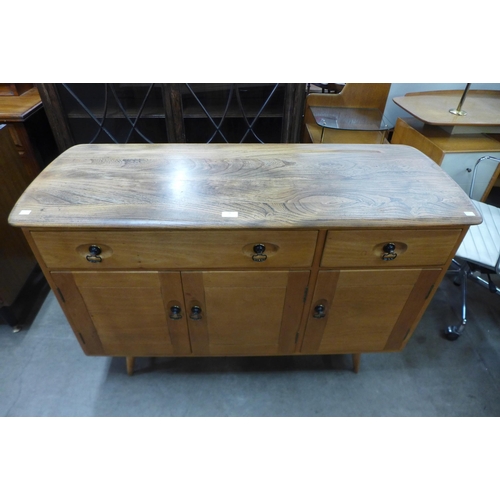 78 - An Ercol elm and beech Windsor sideboard