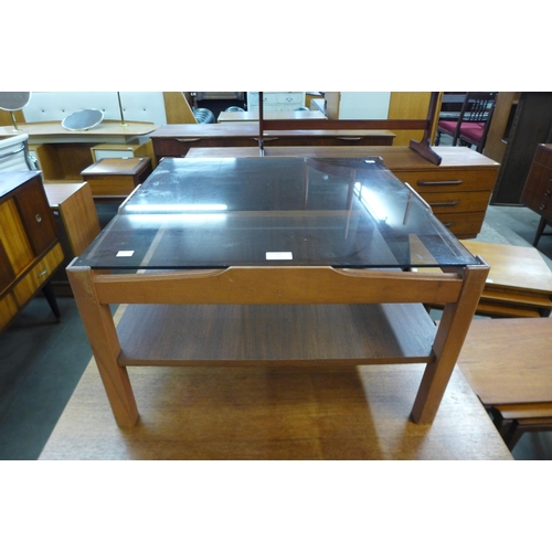 82 - A teak and glass topped square coffee table