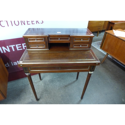 9 - A 19th Century French mahogany and brass mounted bonheur de jour