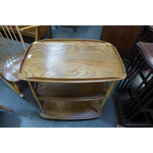 99 - An Ercol elm and beech Windsor trolley