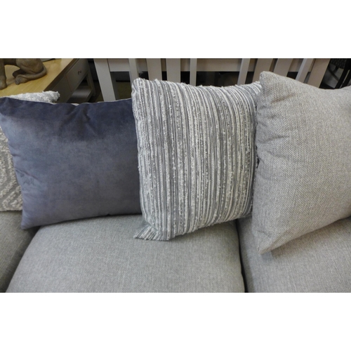 1301 - A designer grey upholstered corner sofa/chaise with contrasting footstool