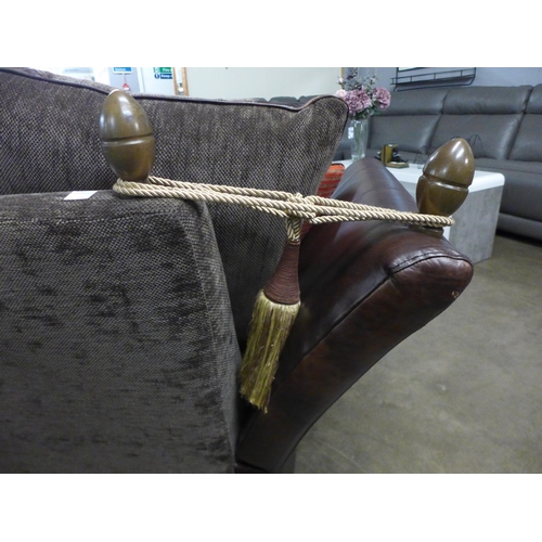 1305 - A designer Knowle leather drop arm sofa retailed in Barker & Stonehouse